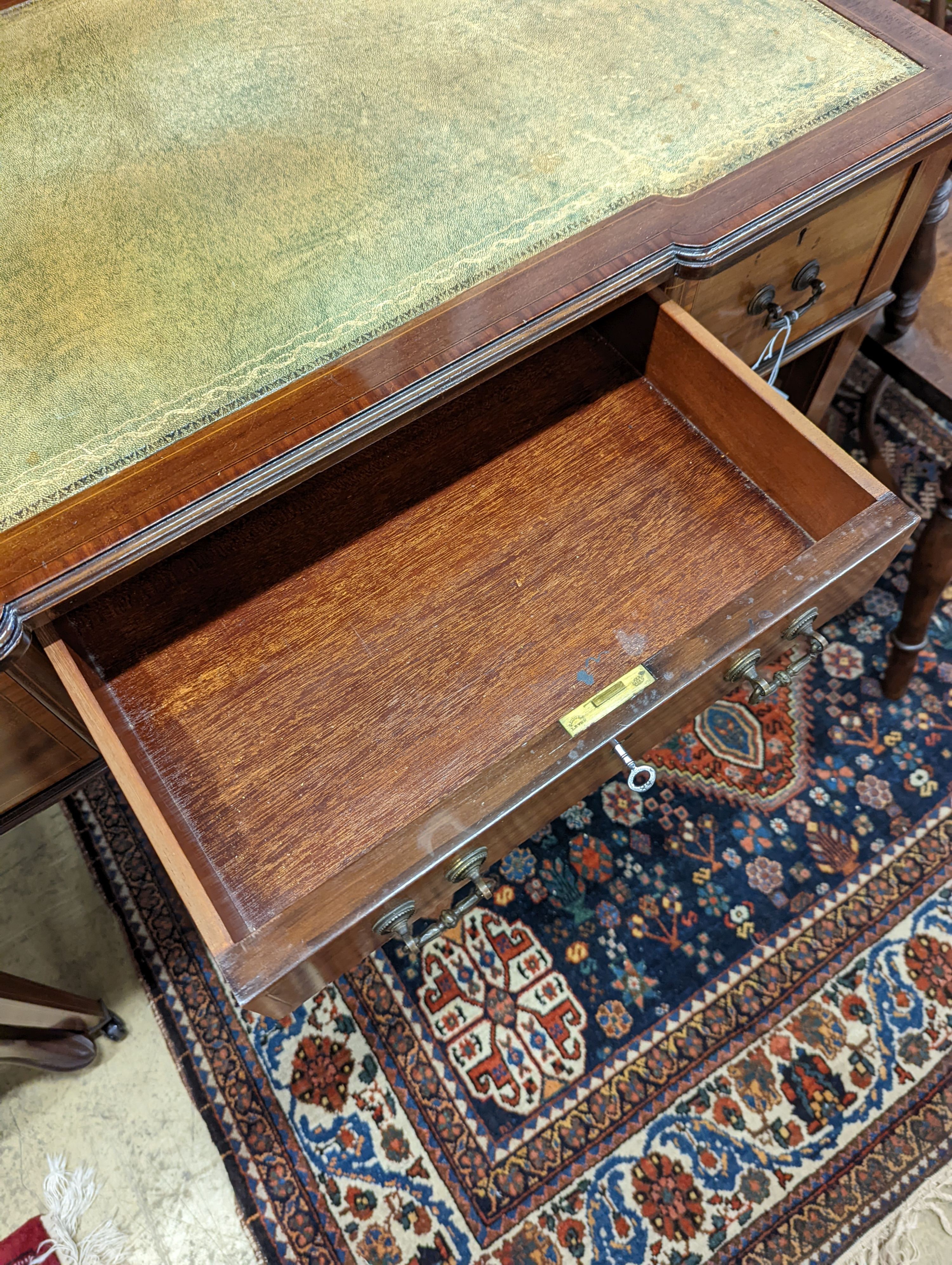 An Edwardian satinwood banded mahogany three drawer writing table, width 99cm, depth 53cm, height 75cm